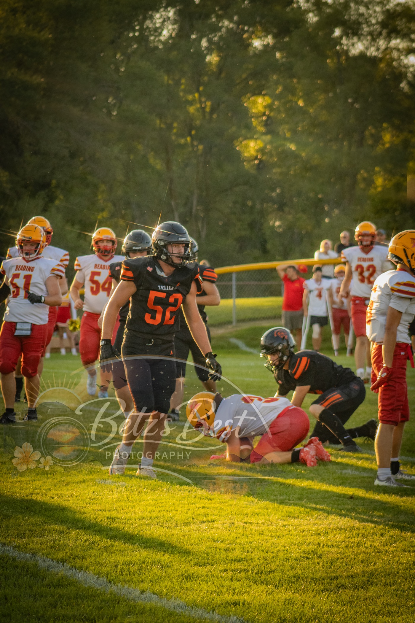 Homer Trojans football player on the field at golden hour