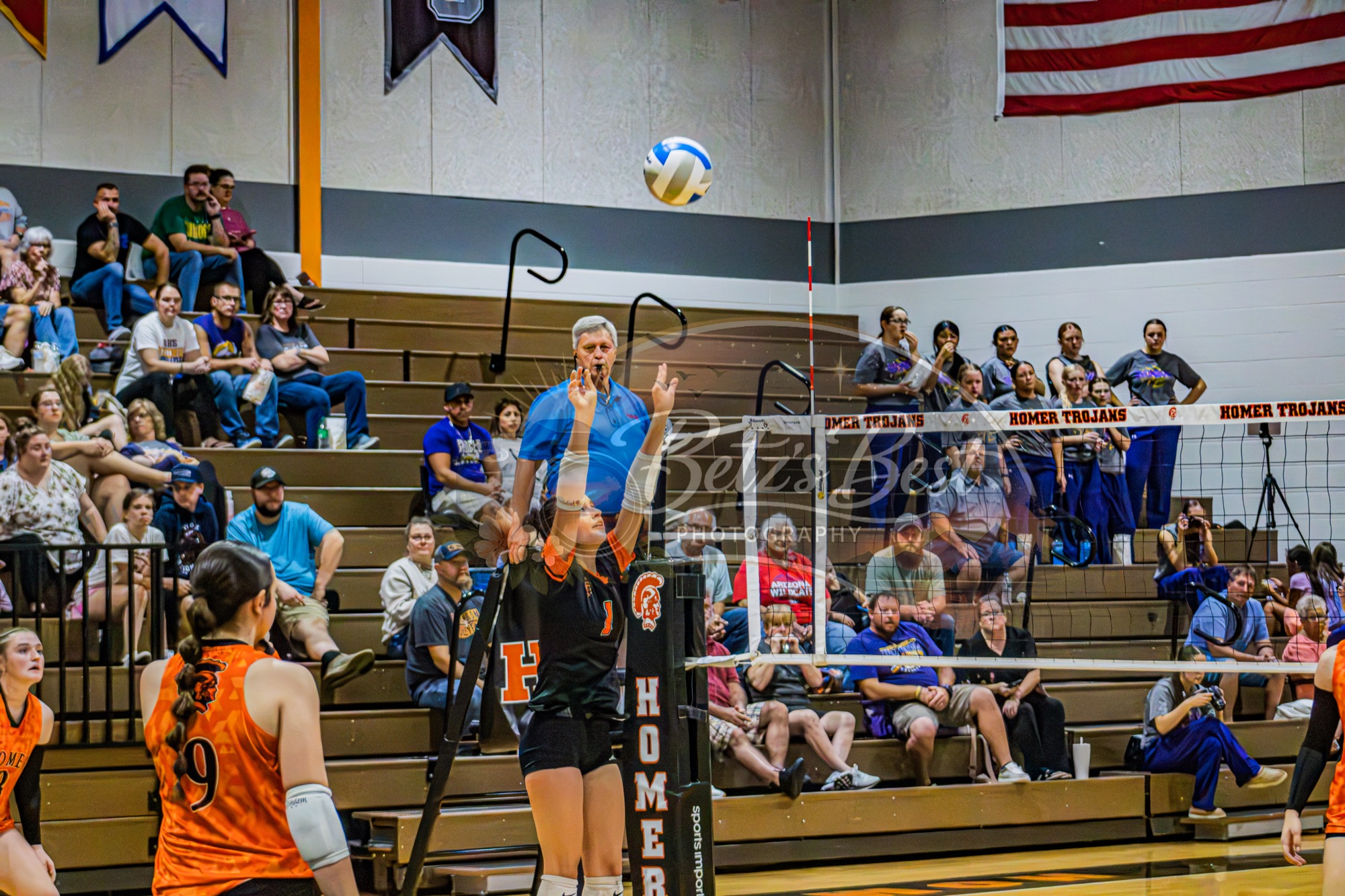 Homer Trojans volleyball player serving the ball